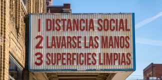 Spanish movie cinema billboard with three rules to avoid the coronavirus epidemic. Translation, wash hands, maintain social distance, clean surfaces